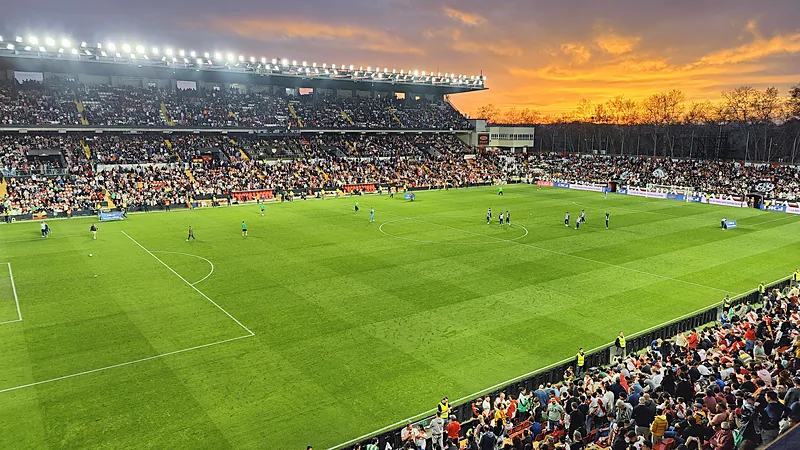 Tiga Penyelamatan Emil Audero Bantu Rayo Tekuk Espanyol 2-1 Estadio de Vallecas dengan tribun penuh penonton dan lampu stadion menyala saat langit senja berwarna jingga