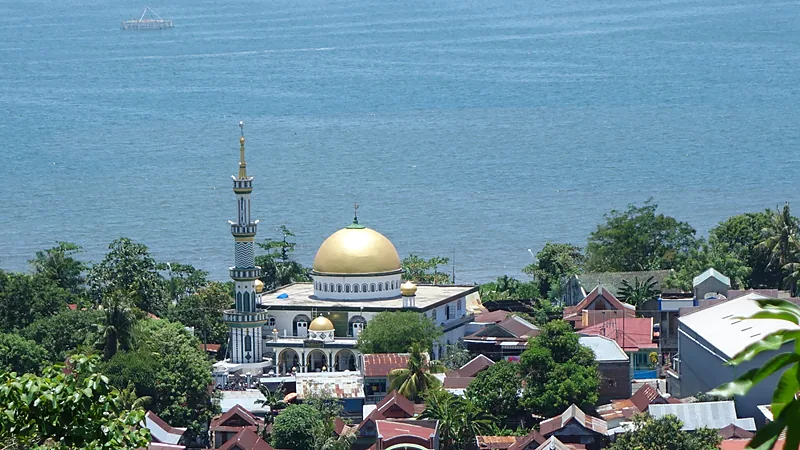 Pemandangan Kota Parepare dari ketinggian dengan kubah emas masjid, atap rumah warga, dan laut di kejauhan